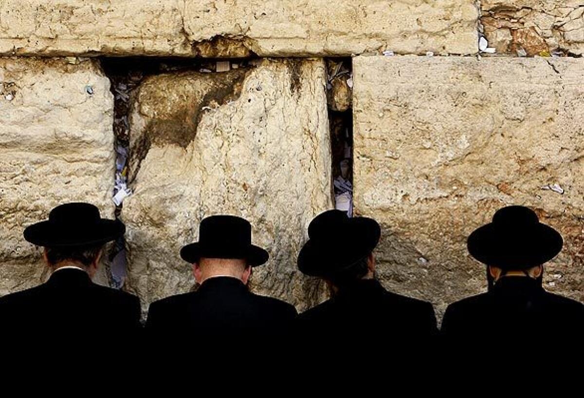 Men pray at Jerusalem's Western Wall before the start of Yom Kippur.