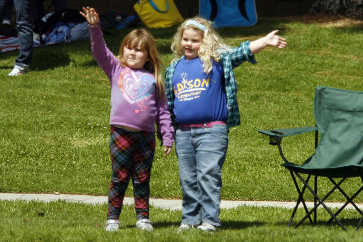 Meghan Hesley, 6, left, and Madison Lynch, 6, wave to participants during Burbank on Parade, which took place on Olive Ave. between Keystone St. and Lomita St. on Saturday, April 14, 2012.