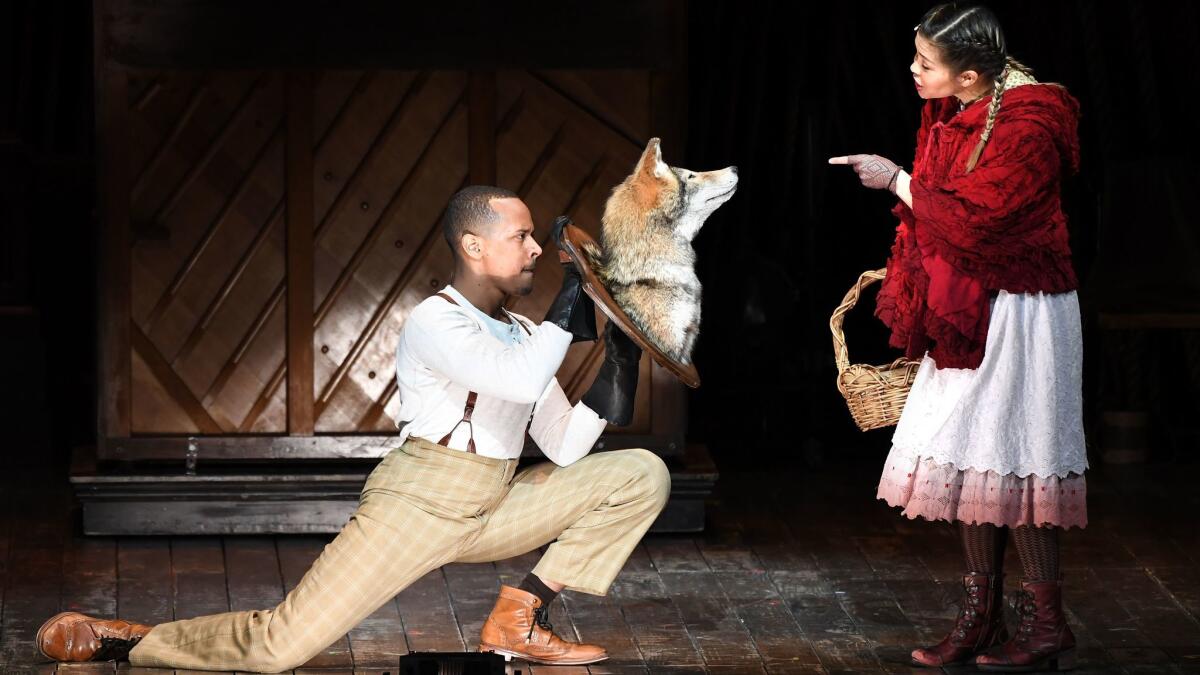 Anthony Chatmon II plays the Wolf and Lisa Helmi Johanson is Little Red Ridinghood in Fiasco Theater's "Into the Woods" at the Ahmanson in Los Angeles.