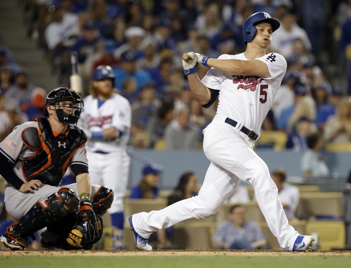 Dodgers shortstop Corey Seager hits a triple to right field during the seventh inning.