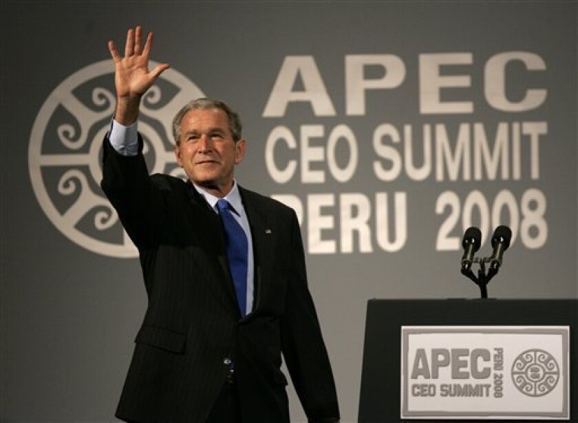 President George W. Bush waves after addressing the CEO summit at the Asia Pacific Economic Cooperation, APEC, in Lima, Saturday, Nov. 22, 2008. (AP Photo/Dado Galdieri)