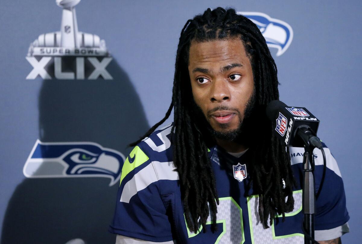 Seattle Seahawks cornerback Richard Sherman answers a question during a Super Bowl XLIX news conference in Phoenix on Jan. 28.