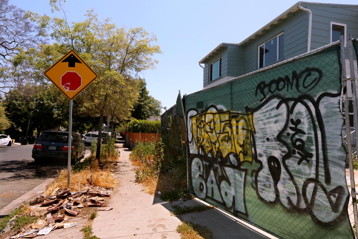  A fence surrounding a home is covered with graffiti