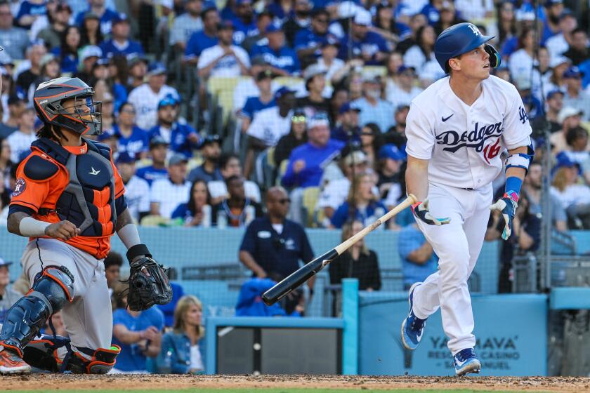 Dodgers catcher Will Smith hits a home run against the Houston Astros on June 25, 2023, at Dodger Stadium. 