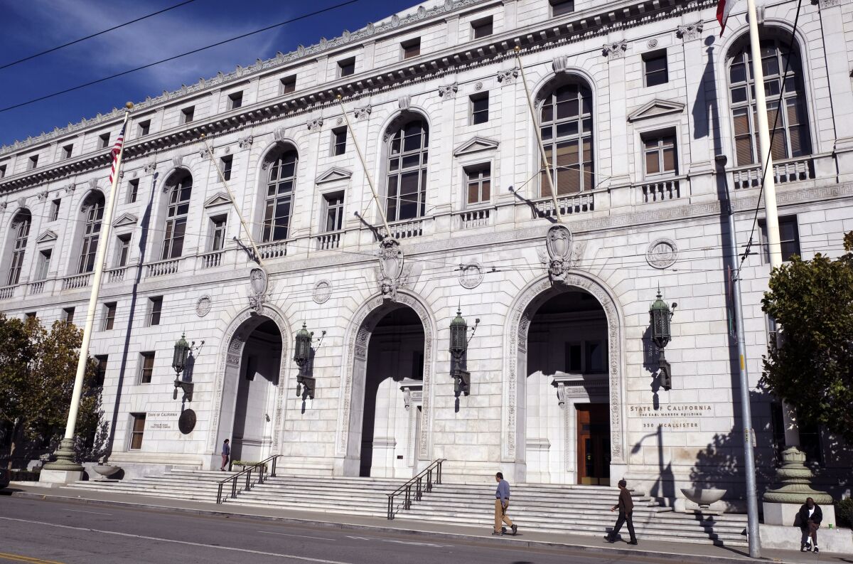 People walk past the Earl Warren Building that houses the California Supreme Court in San Francisco