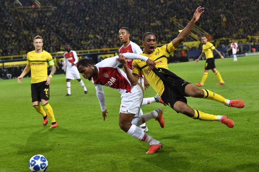 Dortmund's Abdou Diallo fights for the ball with Monaco forwarder Samuel Grandsir.