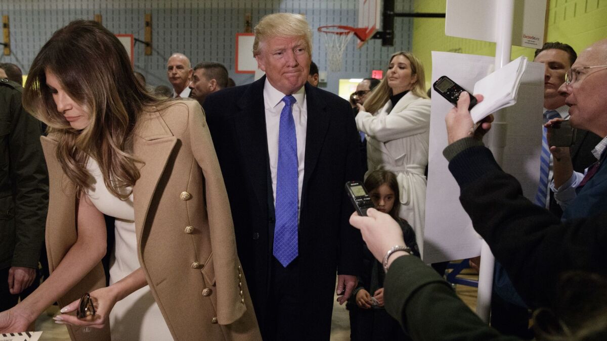 Melania Trump votes wearing a Michael Kors dress and Balmain coat.