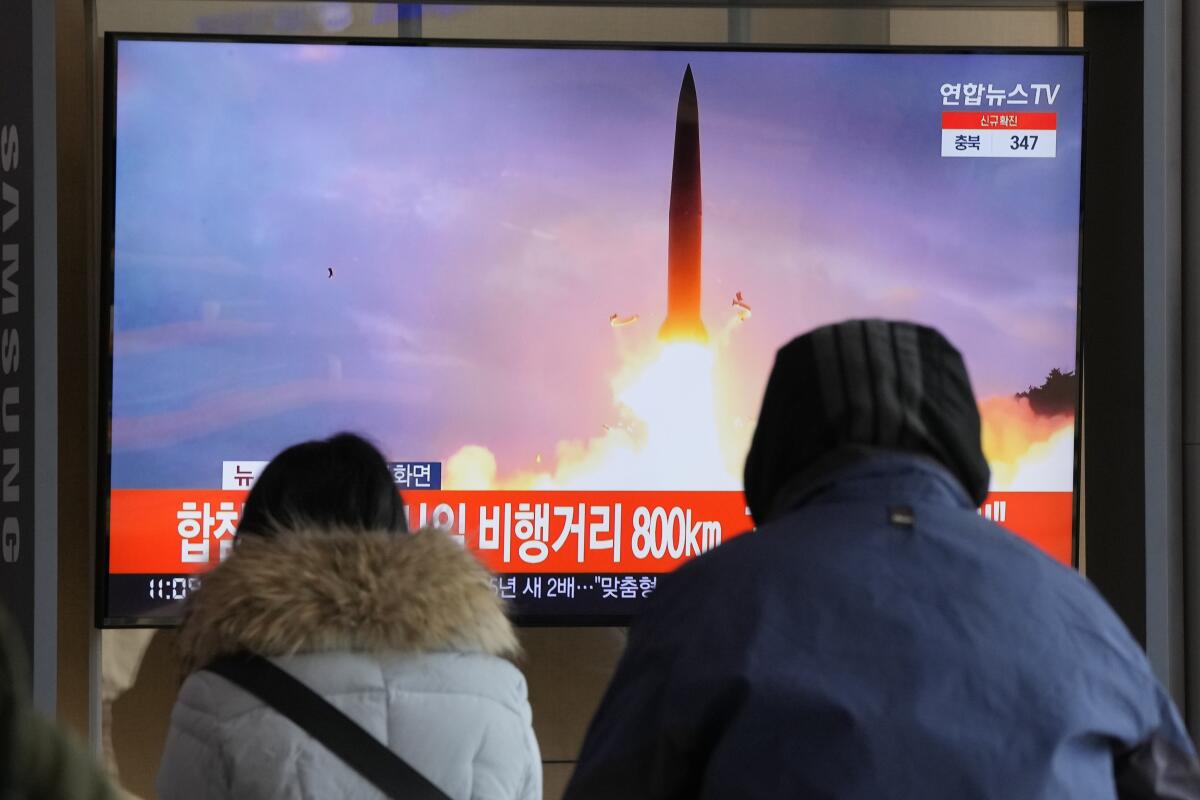 People in Seoul watch a television broadcast of North Korea's missile launch.