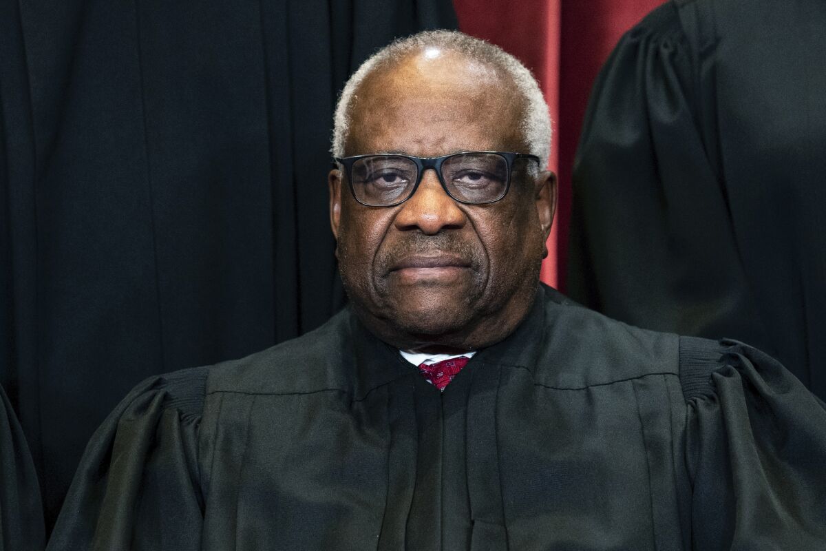 FILE - Associate Justice Clarence Thomas sits during a group photo at the Supreme Court in Washington, Friday, April 23, 2021. On Monday, Feb. 7, 2022, Georgia’s state Senate voted to erect a monument to U.S. Supreme Court Justice and Georgia native Thomas. (Erin Schaff/The New York Times via AP, Pool, File)