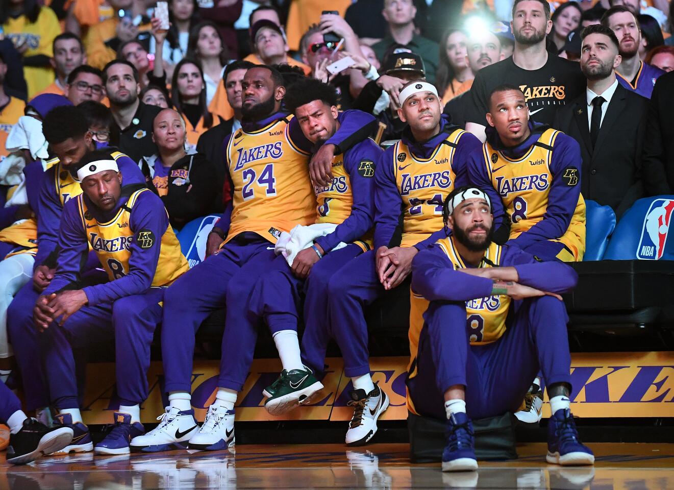 The Lakers hold each other close during a performance by Usher honoring Kobe Bryant on Jan. 31 at Staples Center.