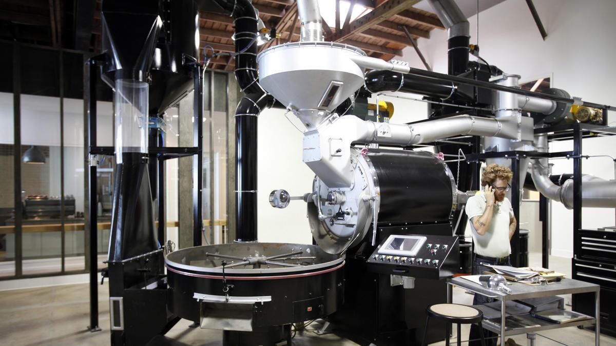 Spencer Moody works on the coffee roaster at Stumptown Coffee Roasters in the Arts District in downtown Los Angeles.