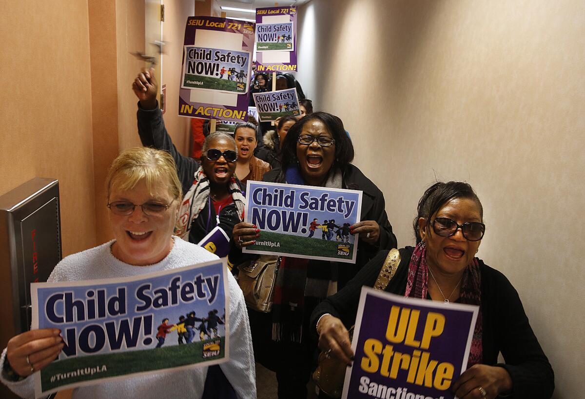 L.A. County children's social workers march through the hallway after trying to see County Supervisor Gloria Molina at her field office in El Monte.