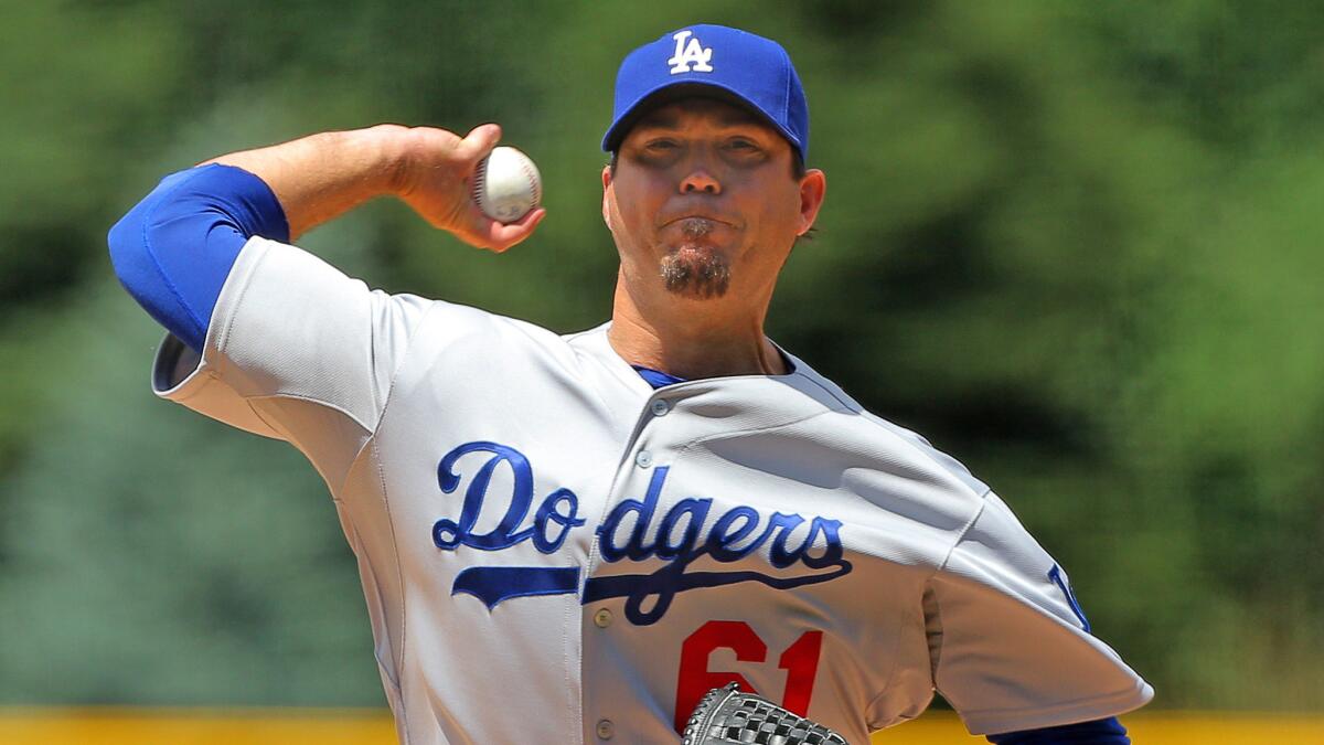 Dodgers starter Josh Beckett delivers a pitch during the first inning of the team's 8-2 win over the Colorado Rockies on Sunday.