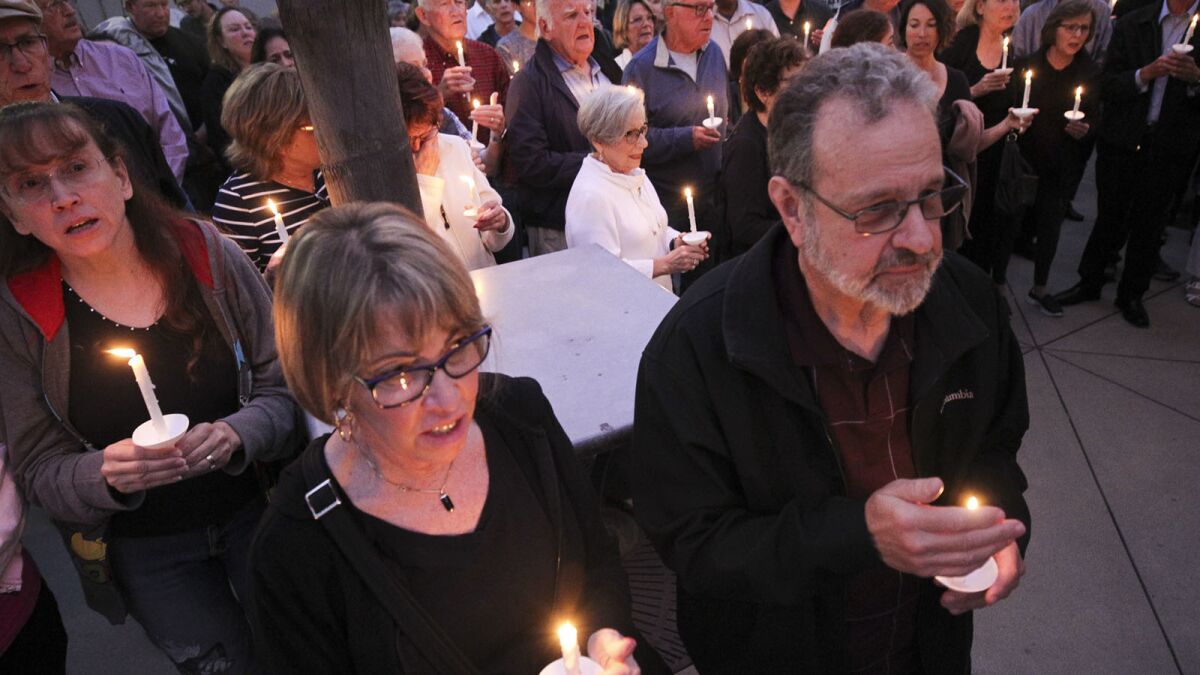 People of various faiths from the Poway community join members of the Rancho Bernardo Community Presbyterian Church in a vigil.