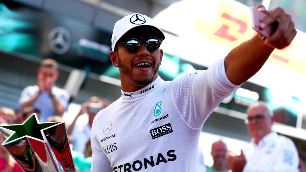 Formula One driver Lewis Hamilton celebrates by taking a selfie after winning the Italian Grand Prix on Sunday.