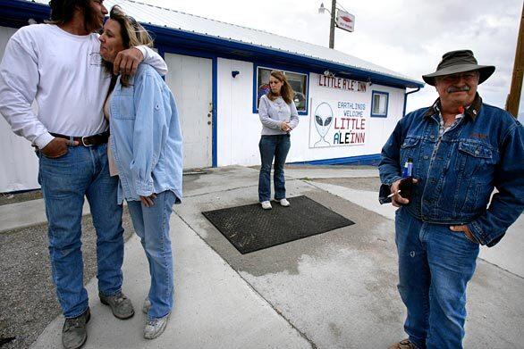 Outside the Little A'Le'Inn motel, restaurant and bar in Rachel, Nev., are, from left, Mike Lyons and Marney Macleod of Las Vegas, employee Rhonda Scott, and UFO seeker Lester Arnold of Declo, Idaho. The former Rachel Bar & Grill renamed itself as the tiny town became a mecca for UFO watchers, who might down an Alien Burger on their way to a night of sky watching in the desert near Area 51.