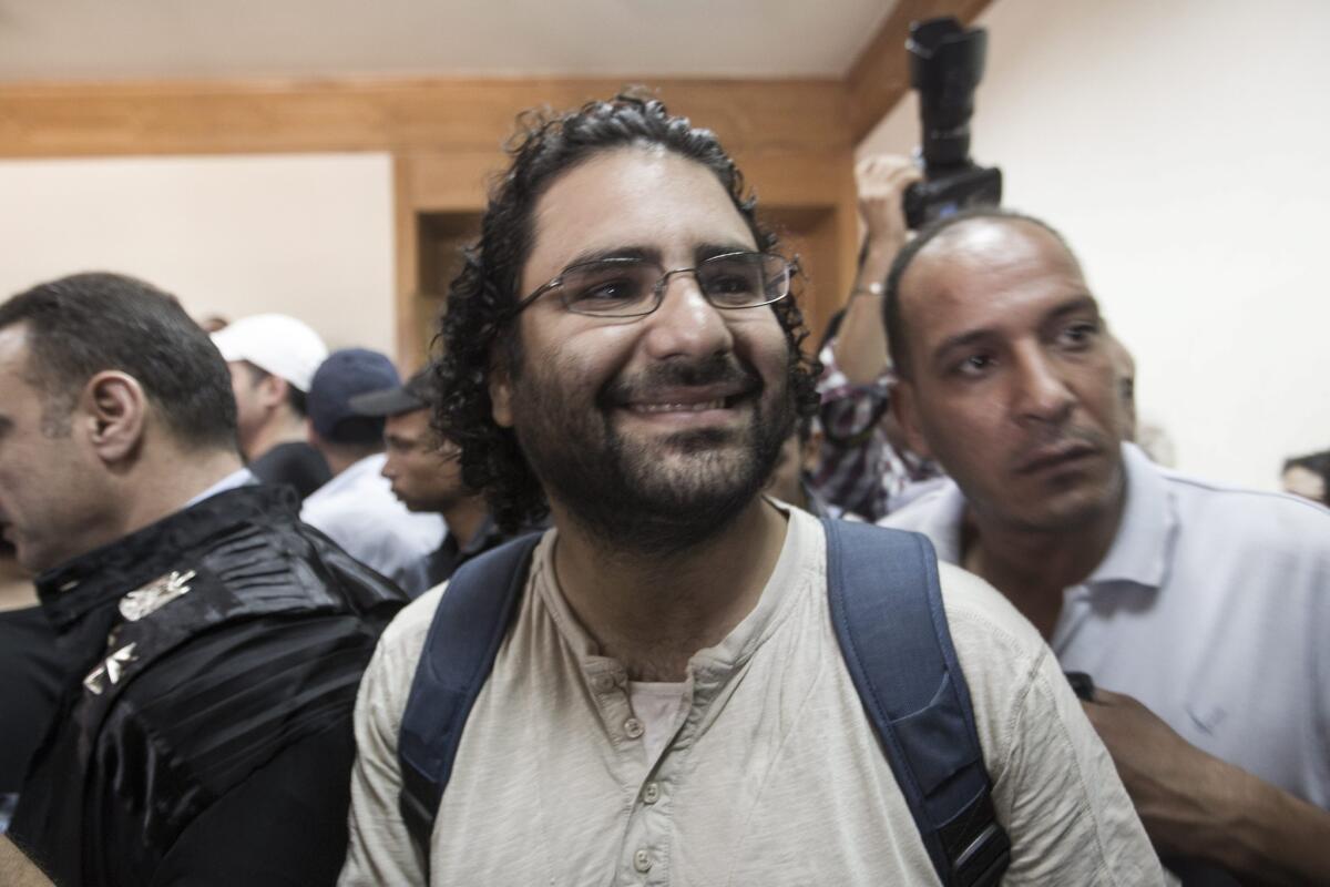 A file photo from June 2013 shows Egyptian activist Alaa Abdel Fattah attending the trial of fellow activist Ahmed Doma in Cairo.