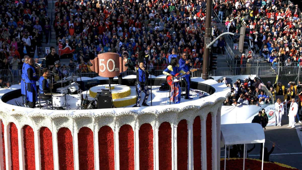 Earth, Wind & Fire performs atop the "50th Anniversary of the Forum" float.