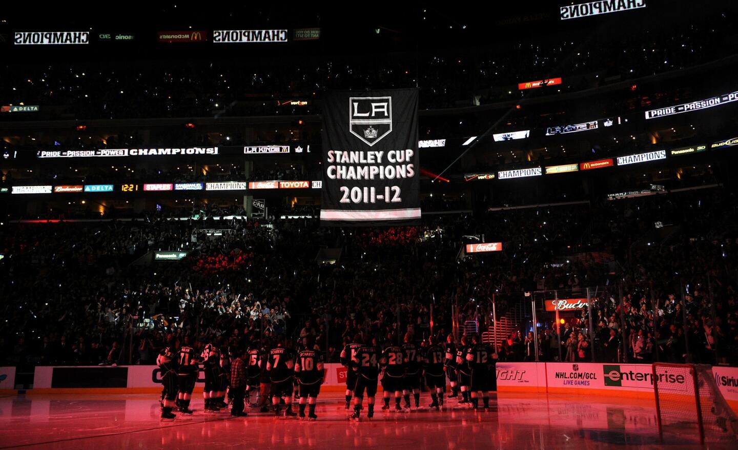 The Kings lift their heads to watch the Stanley Cup banner make its way to the rafters at Staples Center.