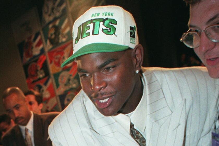 Mandatory Credit: Photo by Wally Santana/AP/Shutterstock (6032858a) KEYSHAWN JOHNSON New York Jets newest member, Keyshawn Johnson, of USC, greets team officials after being the top NFL draft pick in New York NFL DRAFT JETS, NEW YORK, USA
