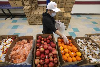 LOS ANGELES, CA - APRIL 21: LAUSD cafeteria crew gets busy in making food bags James A. Garfield High School for distribution among area families. Los Angeles, CA. (Irfan Khan / Los Angeles Times)