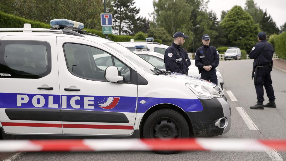 Police officers work in Magnanville, France, where a man claiming allegiance to Islamic State killed a police officer and his partner on June 13.
