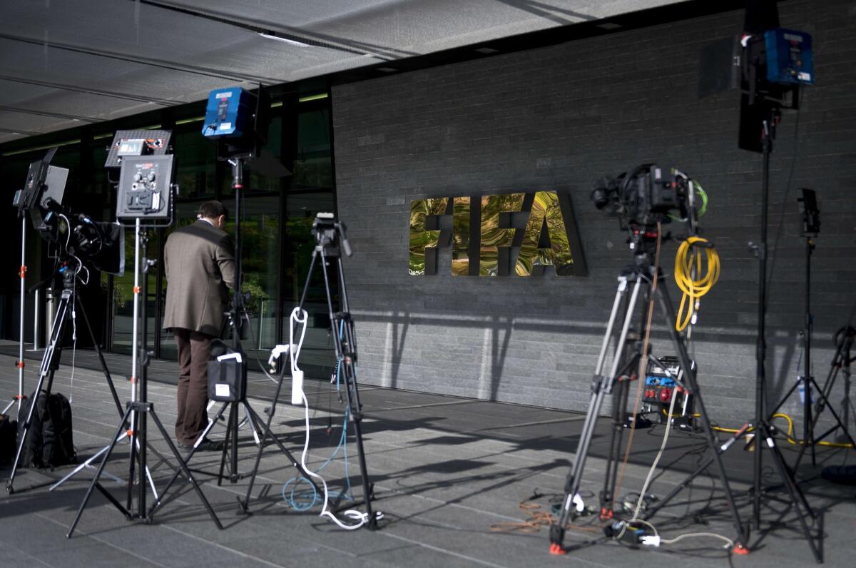 A journalist stands in front the FIFA headquarters on Sept. 25.