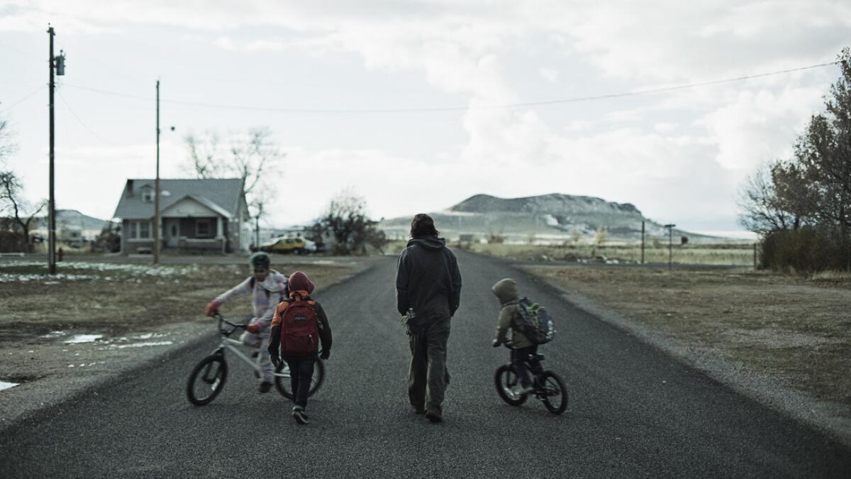 David (Clayne Crawford) walks along an empty town road with his three young sons, two of them on bikes