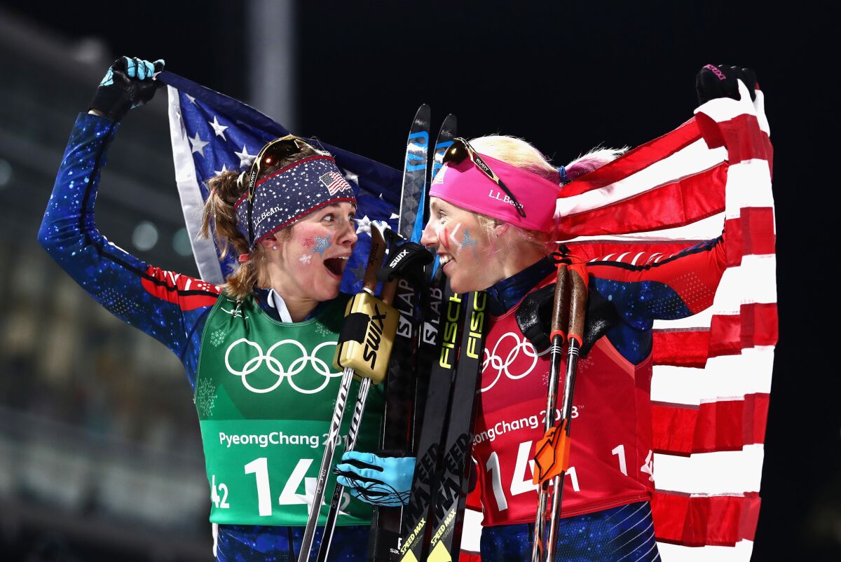 Jessica Diggins and Kikkan Randall celebrate as they win gold.