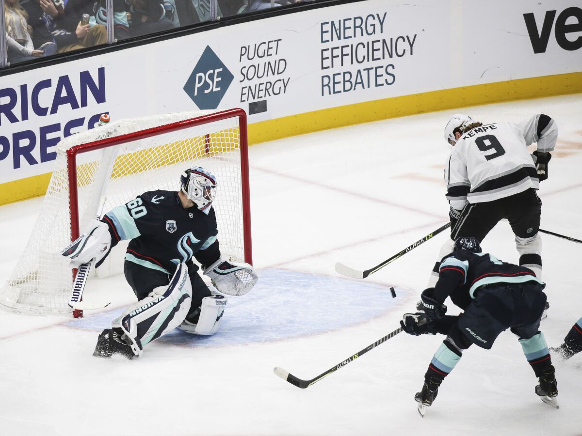 Los Angeles Kings center Adrian Kempe (9) chips the puck in past Seattle Kraken goaltender Chris Driedger (60) to score during the first period of an NHL hockey game, Saturday, Jan. 15, 2022, in Seattle. (AP Photo/Lindsey Wasson)