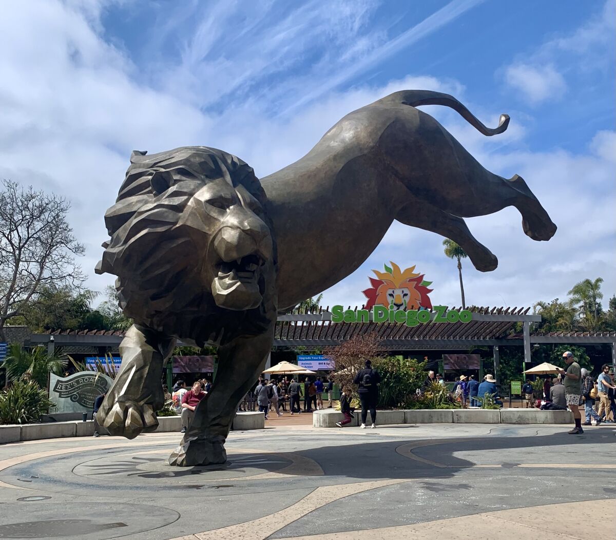 Rex the lion, a monumental 27-foot bronze sculpture, greets visitors at the San Diego Zoo's entrance plaza.