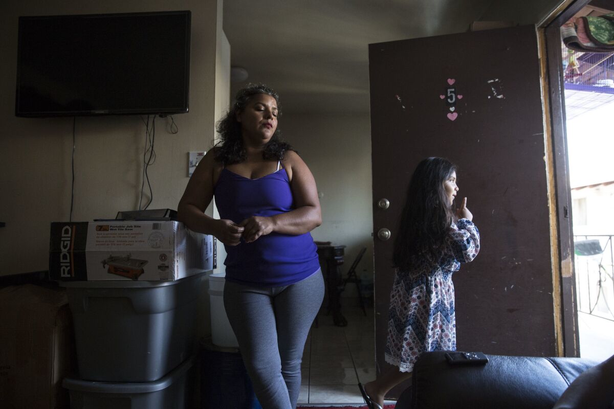Maria Barrancas and her daughter Luz, 6, pack up their apartment in Gardena. (Brian van der Brug / Los Angeles Times)