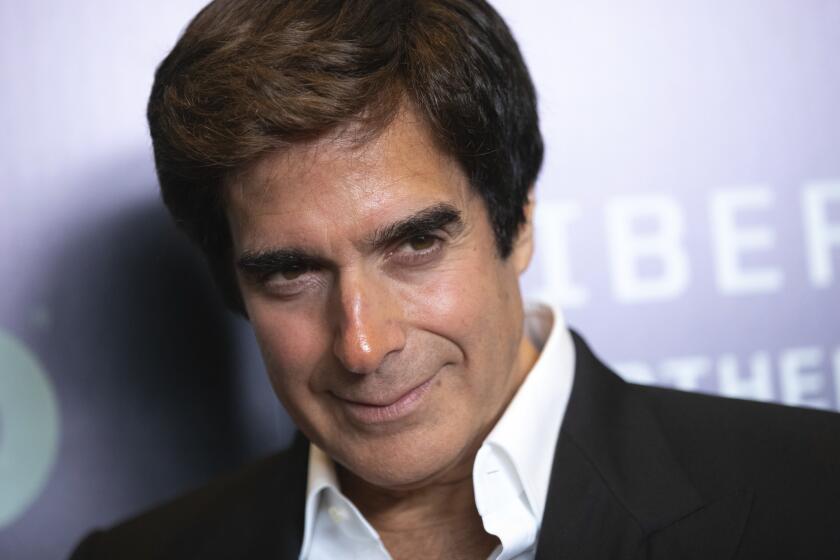 David Copperfield smiles in a suit