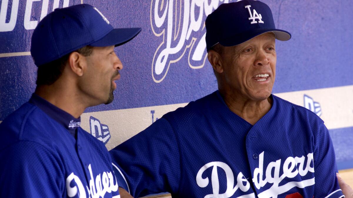 Former Dodgers shortstop Maury Wills, right, chats with outfielder Dave Roberts before the Dodgers' opening day in 2002.