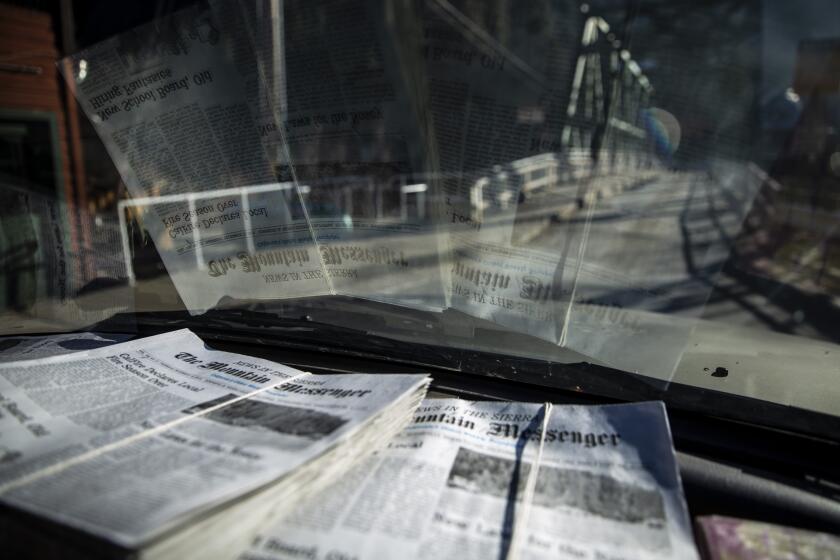 DOWNIEVILLE, CALIF. - DECEMBER 13: Copies of the new issue of the Mountain Messenger sit on Scott McDermid's dashboard as he drives to stock newspaper boxes at the Courthouse and Sheriff's office on Thursday, Dec. 13, 2018 in Downieville, Calif. (Kent Nishimura / Los Angeles Times)