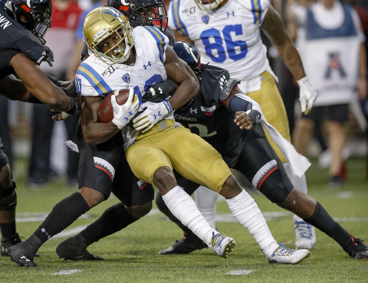 UCLA running back Demetric Felton tries to push for more yards during the Bruins' loss to Cincinnati on Thursday.