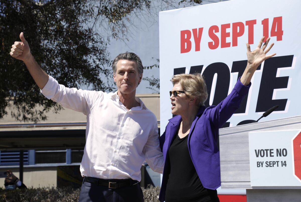 California Gov. Gavin Newsom and U.S. Sen. Elizabeth Warren greet a crowd of supporters.