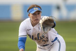 UCLA third baseman Megan Grant (43) catches the ball during an NCAA softball game.