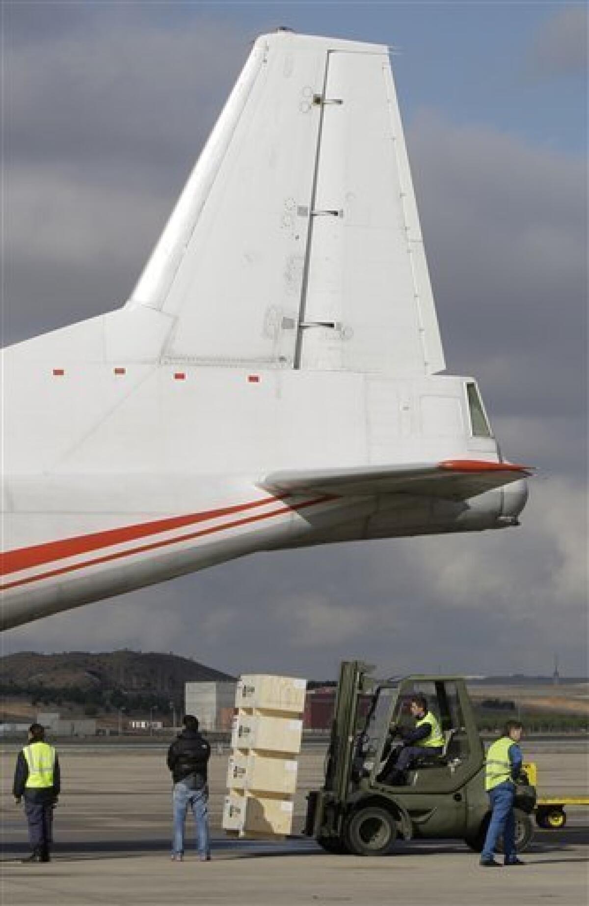 Humanitarian aid is loaded onto a plane at the Torrejon military airbase in Madrid, Spain, Monday Jan. 18, 2010. Aid supplies are being sent from Spain as part of a massive international effort to alleviate the effects of the earthquake in Haiti. (AP Photo/Paul White)
