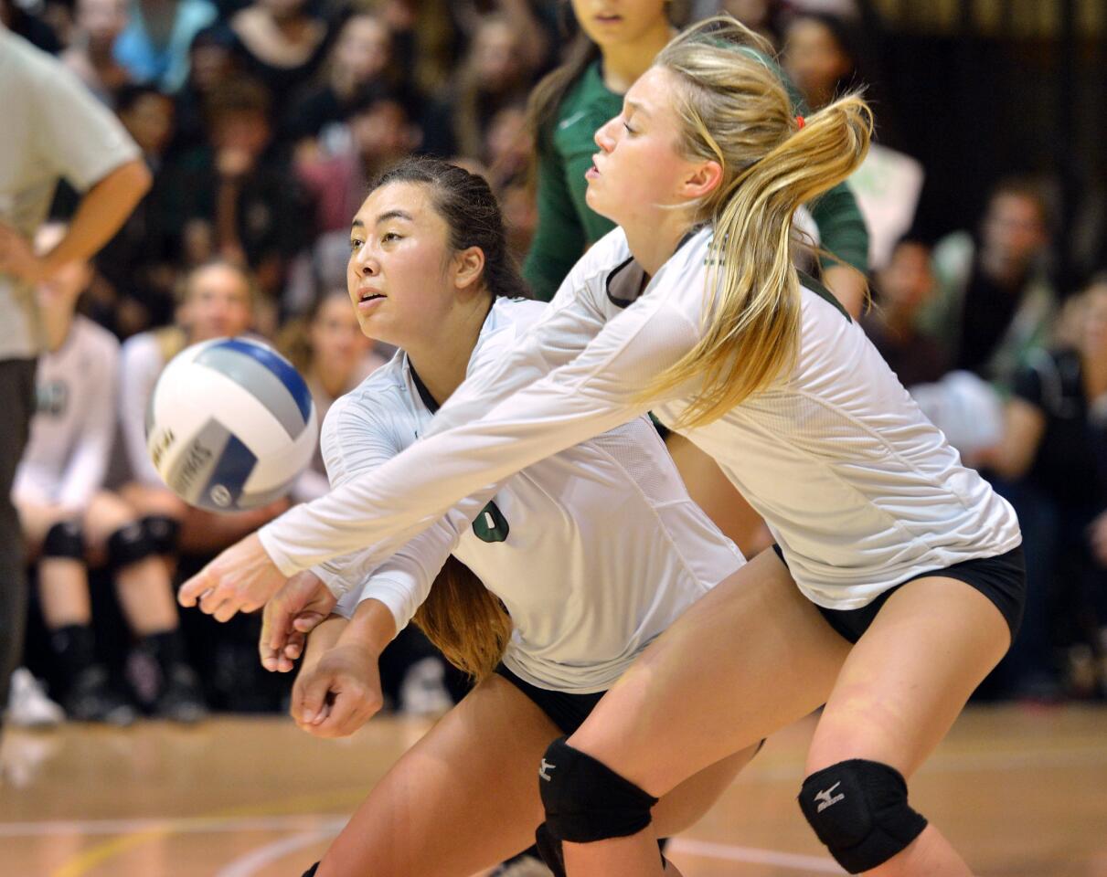 Kekai Whitford, left, and Halland McKenna of Sage Hill moves in to dig the ball during the CIF Southern Section Division 3AA championship girls volleyball match against St. Margaret's at Fullerton College. (Steven Georges - Daily Pilot)
