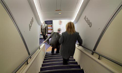 Passengers on the demonstration flight use one of two stairways that connect the main and upper decks aboard the Airbus A380.