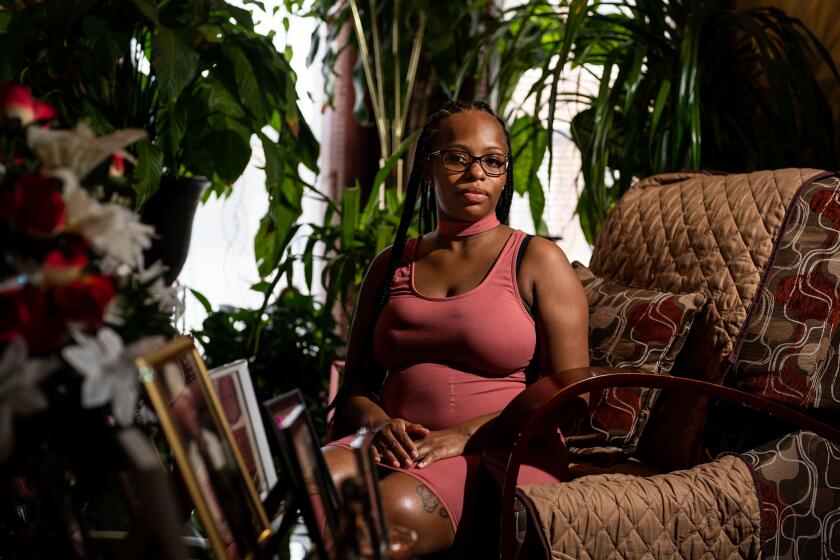 BALTIMORE, MD - SEPTEMBER 21: Brittany Horsey of Baltimore, MD, poses for a portrait in the living room of her Grandmother's home on Tuesday, Sept. 21, 2021 in Baltimore, MD. Horsey was prescribed a drug called Makena during her pregnancies with two children because her doctor believed she was at risk of having them too soon - yet both times the drug didn't work: the babies were born prematurely and Horsey still suffered from Makena's side effects, including being hit by migraines and depression. The FDA has asked Makena's maker to remove the drug from the market because repeated studies have shown it does not work, but the company has refused and continues to promote it. (Kent Nishimura / Los Angeles Times)