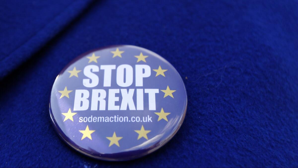 A button worn by a pro-EU demonstrator outside Parliament in London on Wednesday.