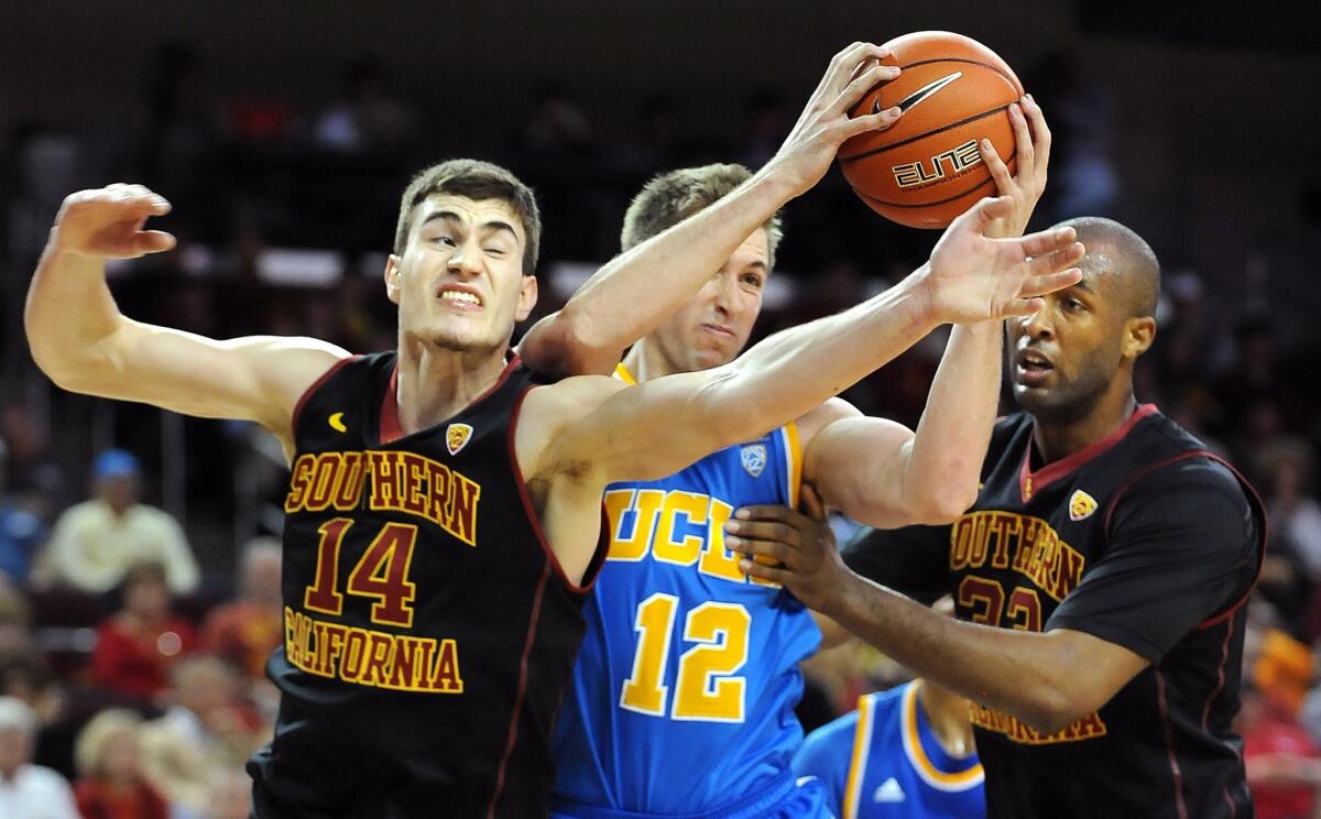 USC's Strahinja Gavrilovic and UCLA's David Wear battle for a rebound during a game on Feb. 8.