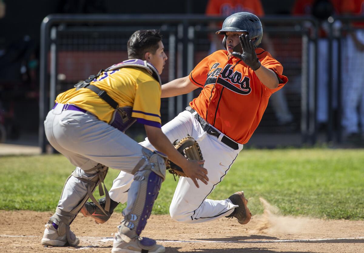 Los Amigos' Steven Esteves beats the throw and scores on a double by Aaron Ramirez against Santiago on April 8.