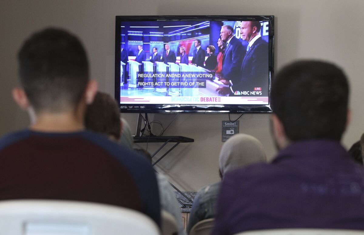 A group of young adults watch the Democratic presidential debate during a watch party, put on by Youth Will, at the Jacobs Center For Neighborhood Innovation on Wednesday, June 26, 2019 in San Diego, California.
