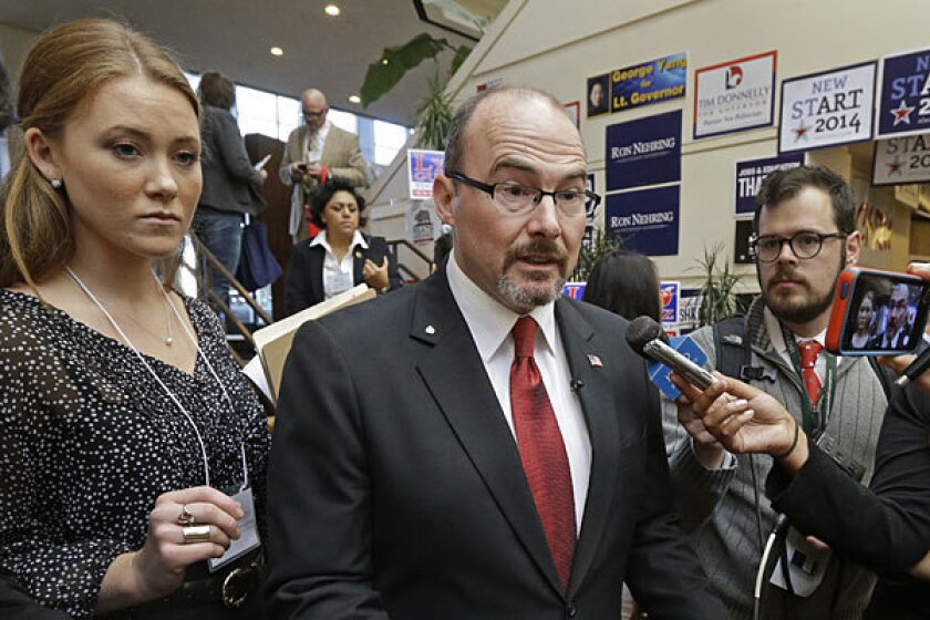 Gubernatorial candidate Tim Donnelly, center, speaks to reporters at the California Republican Party convention in Burlingame on Saturday.