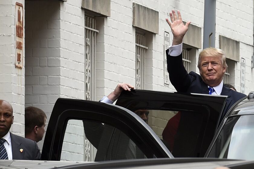 Republican presidential candidate Donald Trump waves as he gets into his vehicle in Washington, Thursday, March 31, 2016, following a meeting at the Republican National Committee. (AP Photo/Susan Walsh)
