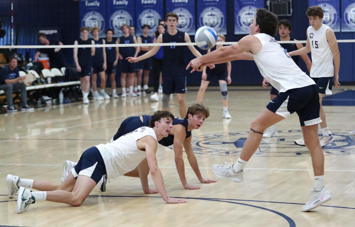 Newport Harbor's Riggs Guy, Walker Vaicek, and Jack Von Der Ahe (3), from left, extend a rally during the Battle of the Bay.