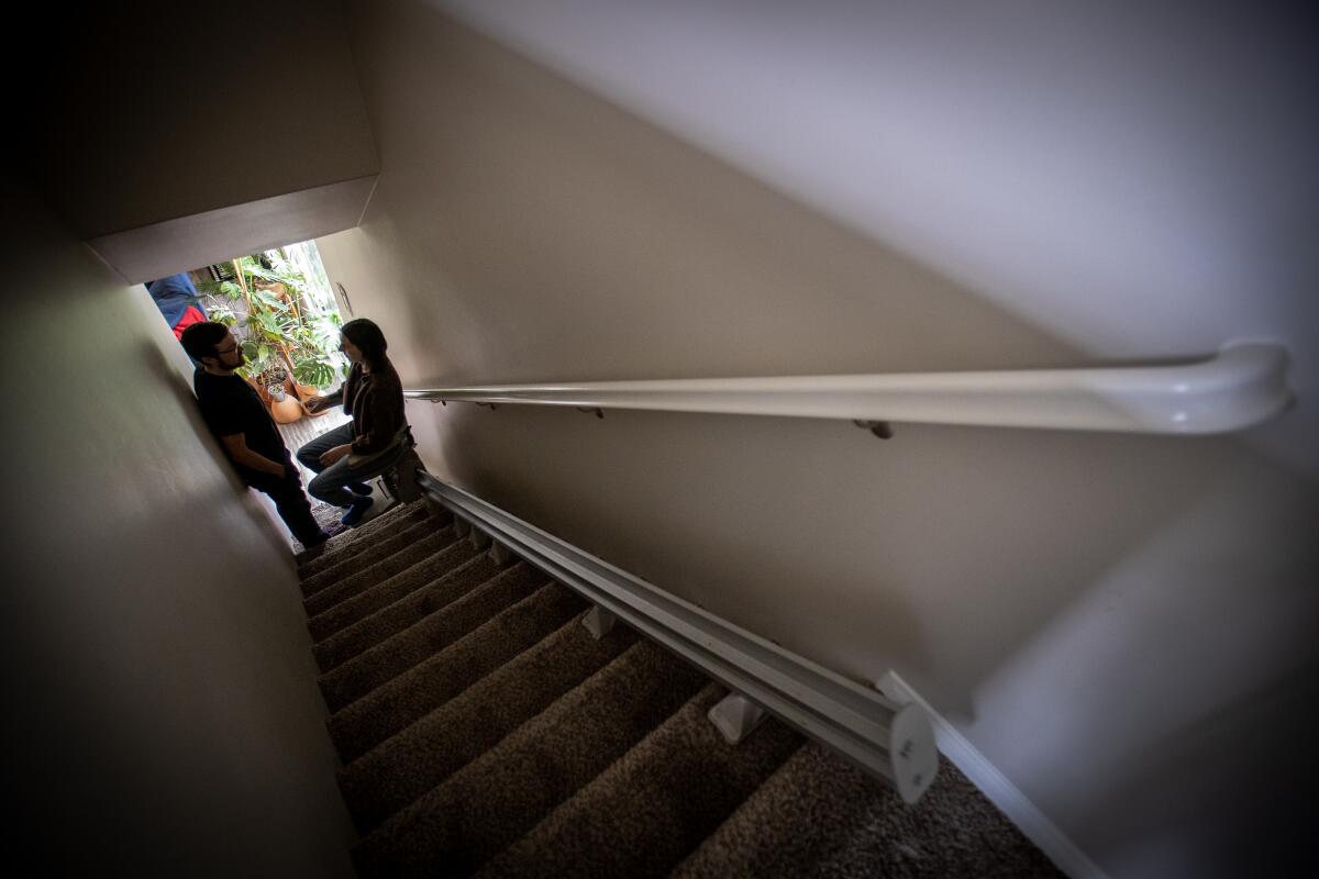 A couple at a home, where one partner has long COVID.